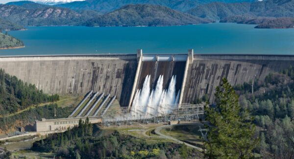 picture-shasta-dam-surrounded-by-roads-trees-with-lake-mountains-scaled